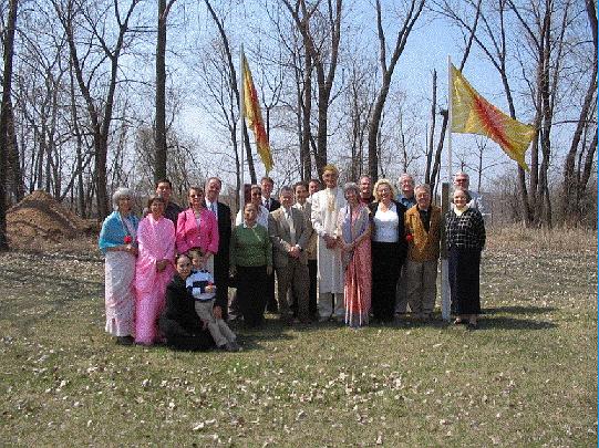 03 cornerstone group.jpg - Members of the Minnesota Peace Palace on the day the cornerstone was laid. Raja Graham, Raja of Invincible Norway, and his wife Leanne, are in the centre; flags of the Global Country of World Peace flutter in the background.